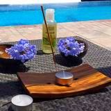 incense, candle and flowers next to the massage table